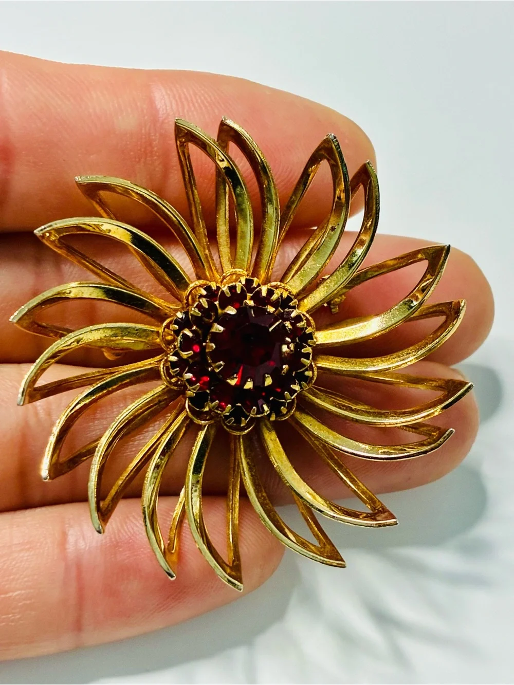 Sarah Coventry Gold-tone Sunburst Brooch with Deep Red Center